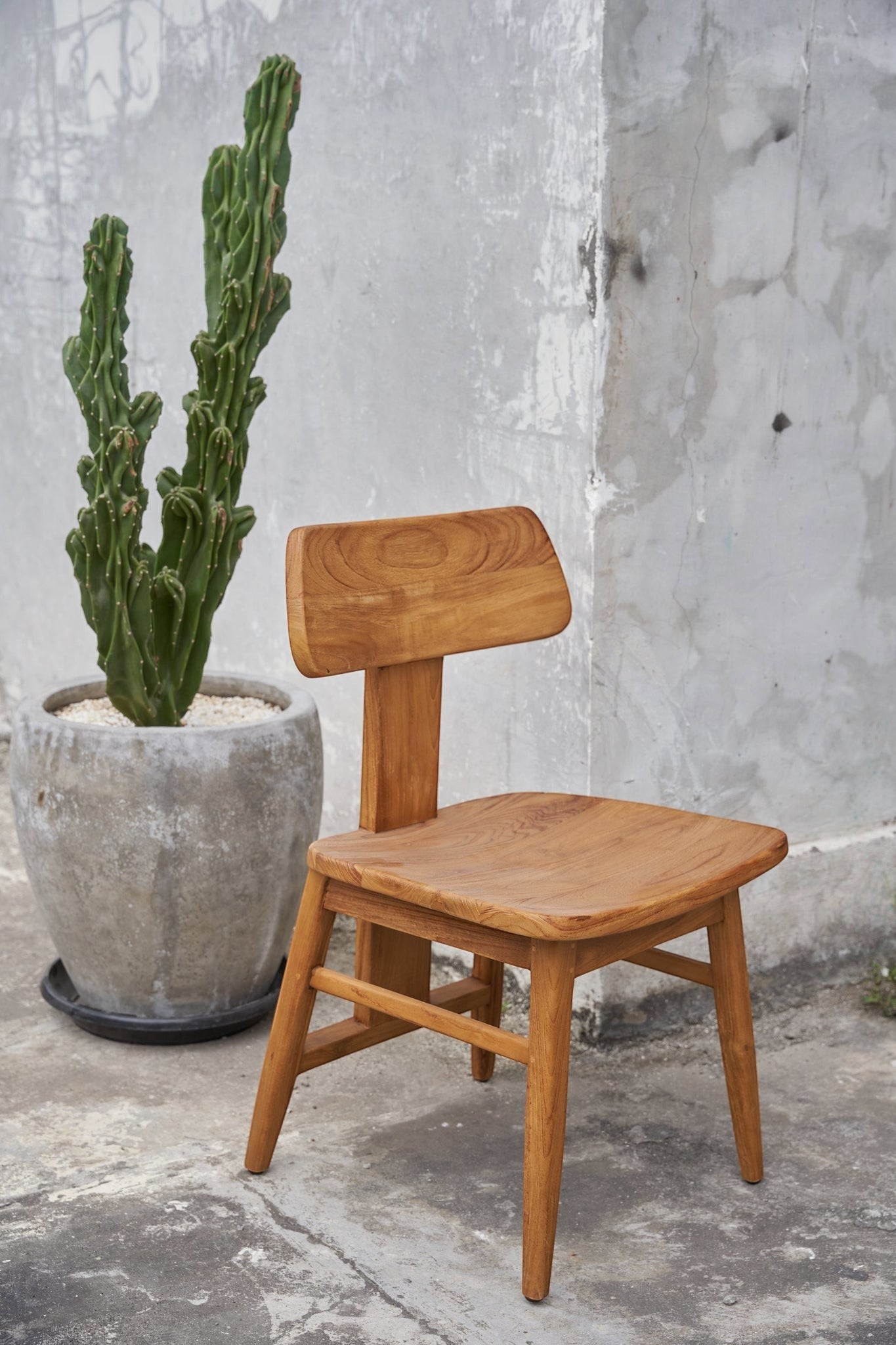 Kayu Living The LovYa teak dining chair with a natural wood finish, featuring a modern minimalist design.