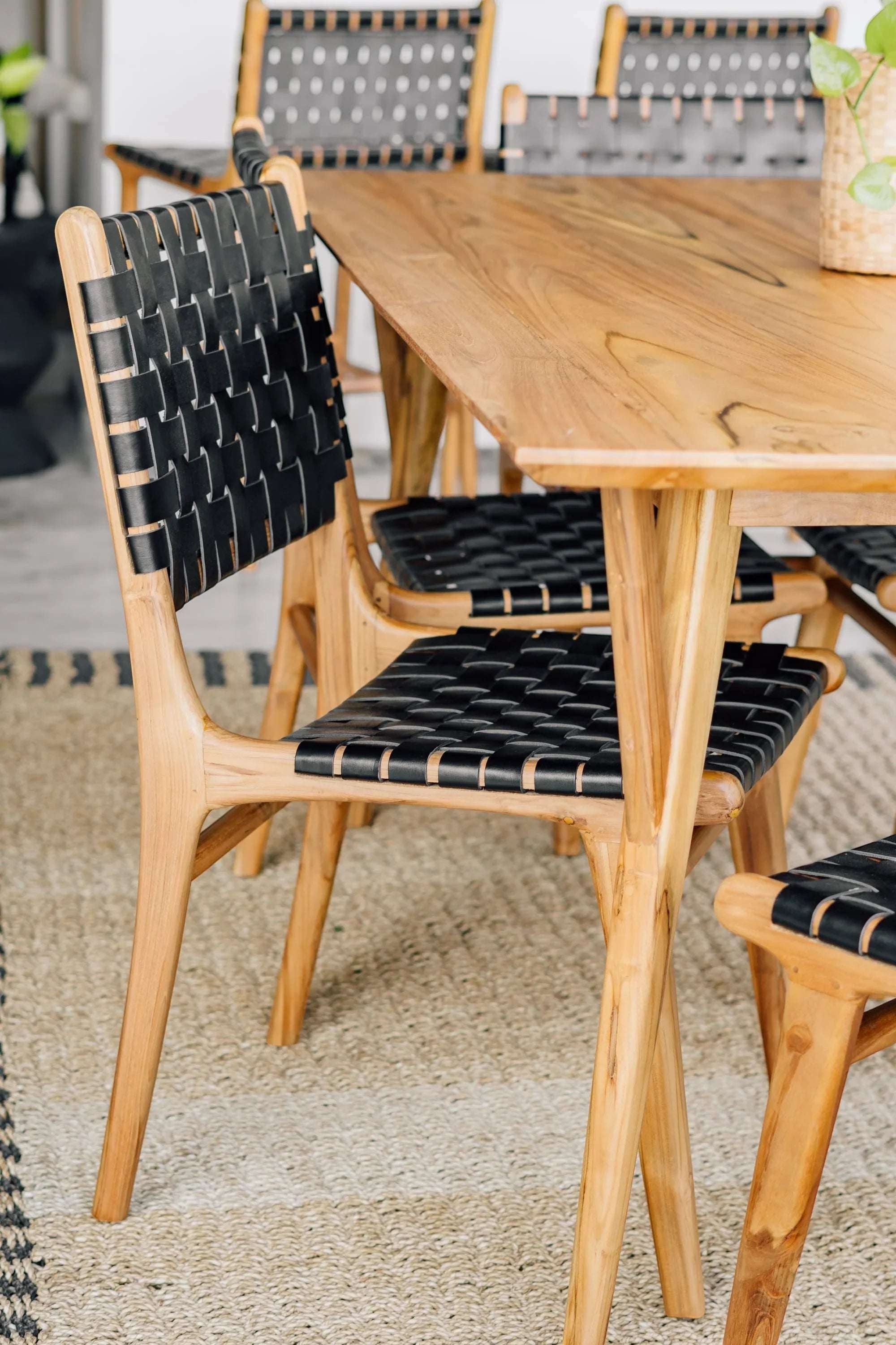 Kayu Living Berawa teak dining table with woven black leather chairs, 180x100 cm.