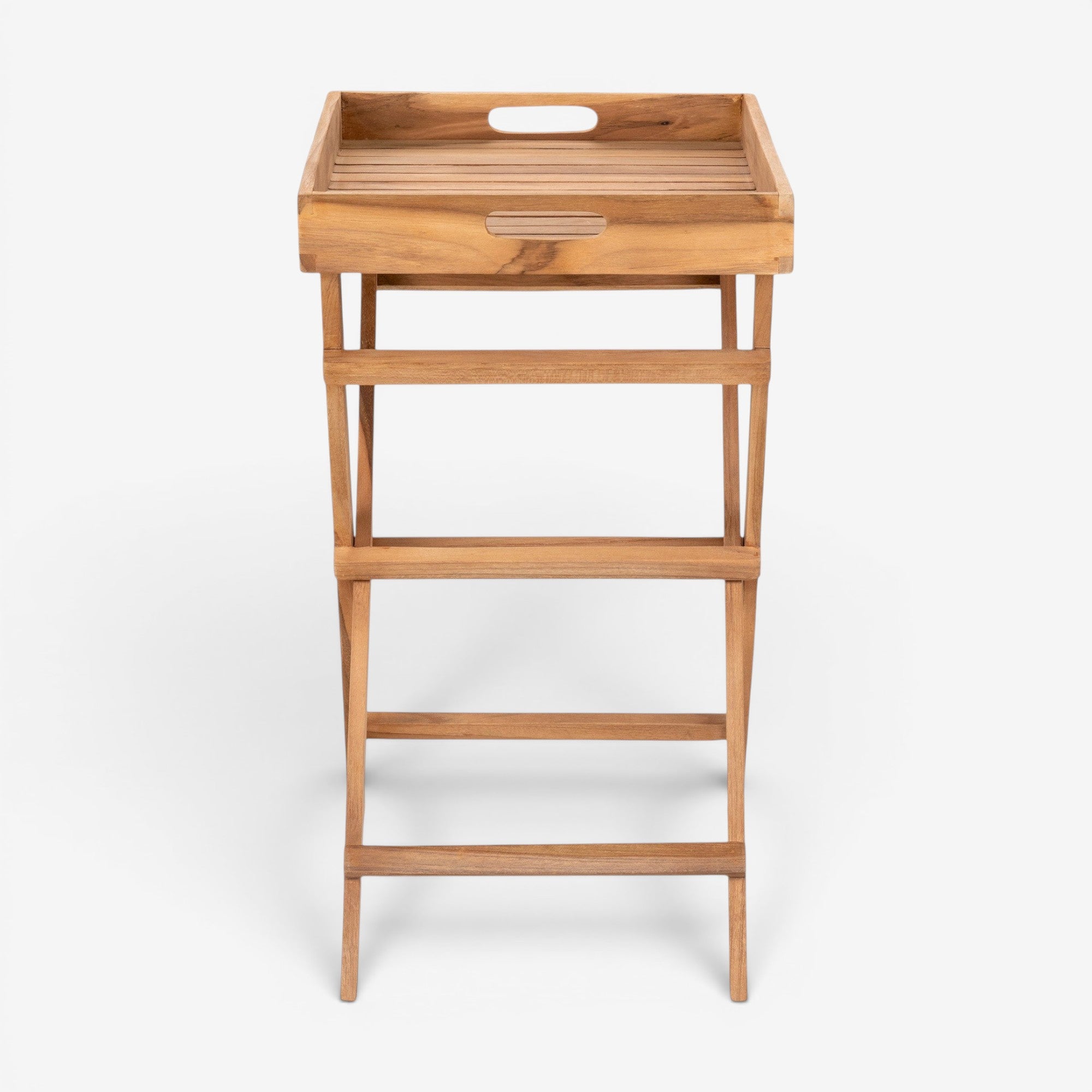 Kayu Living natural teak tray table with warm finish, featuring slatted top and cut-out handles. Versatile side table.