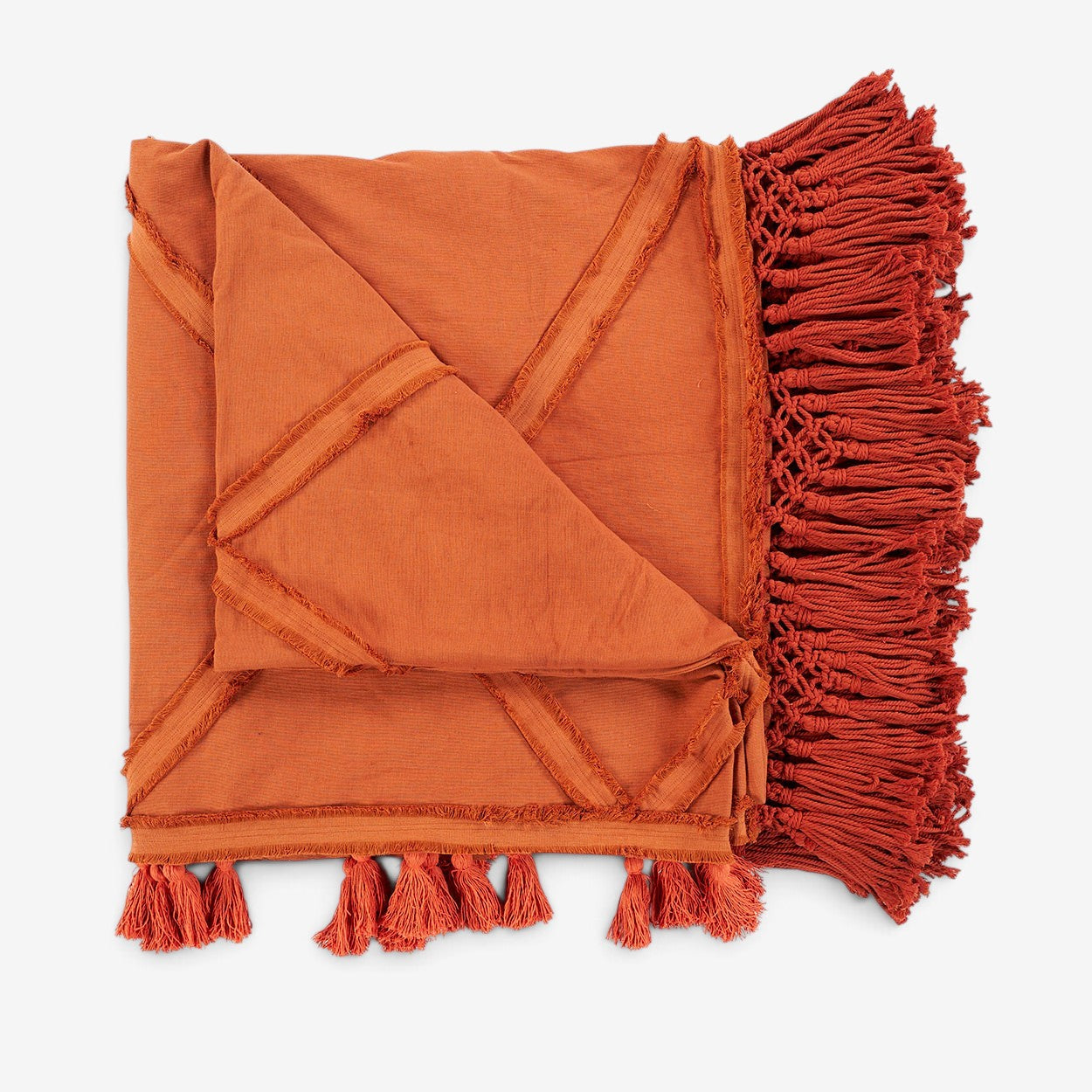 Kayu Living terracotta cotton throw blanket with a plaid pattern, frayed edges, and decorative knotted fringe ends.