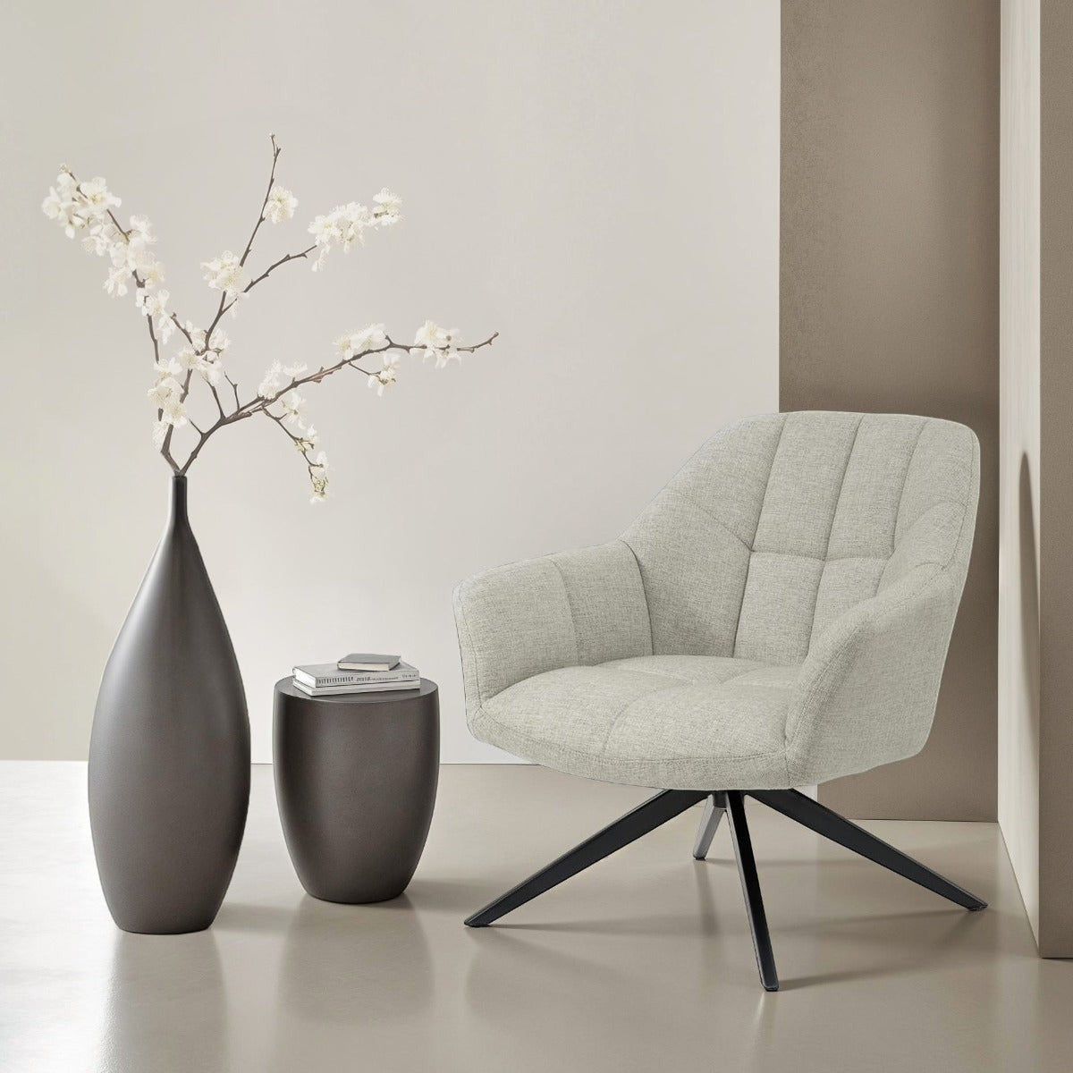 Kayu Living Tom swivel chair in sand fabric with a black metal base, styled with a modern vase and side table.