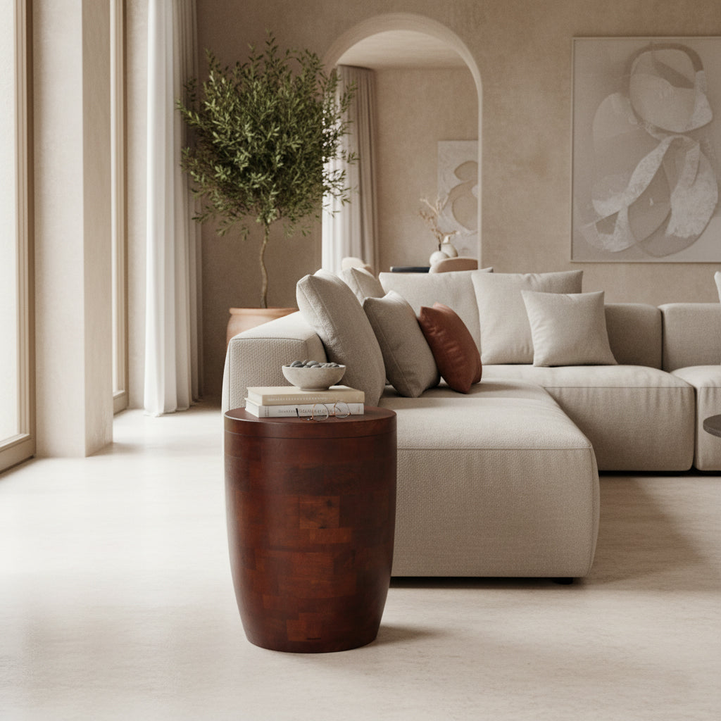 Kayu Living Tuvalu solid mango wood stool or side table with a rich brown finish in a modern living room setting.
