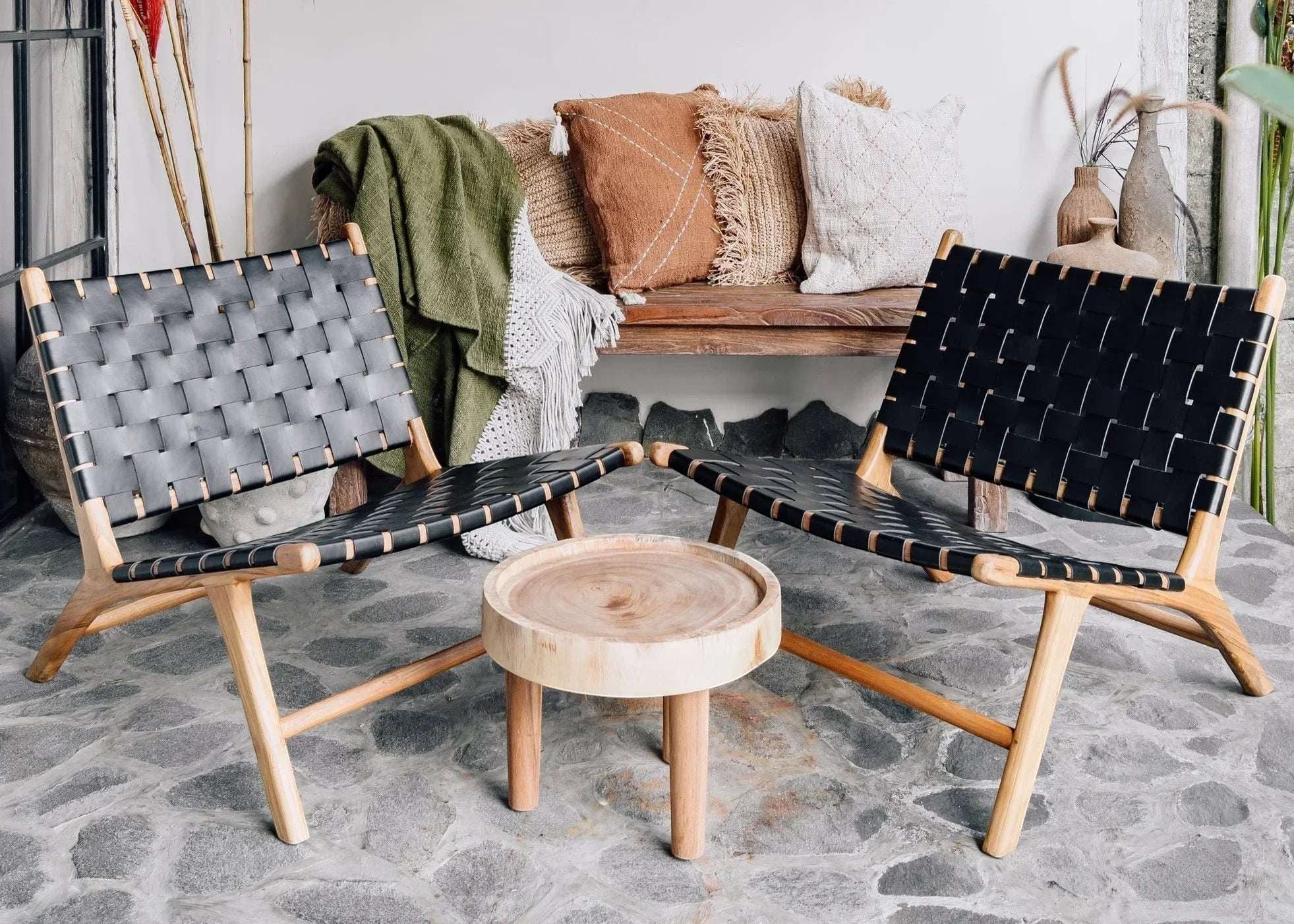 Kayu Living Ulu side table made of light suar wood with a round top and three legs. Natural wood grain.