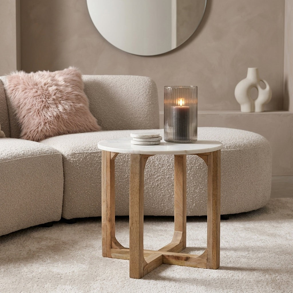 Kayu Living white marble side table with a solid mango wood cross-shaped base in a modern living room setting.